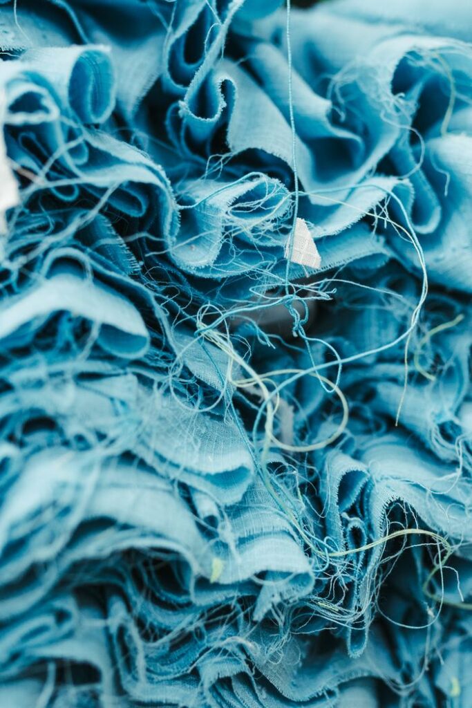 The Art of Drawing Readers In: Your attractive post title goes here An artistic close-up of blue fabric showcasing intricate textures and threads.