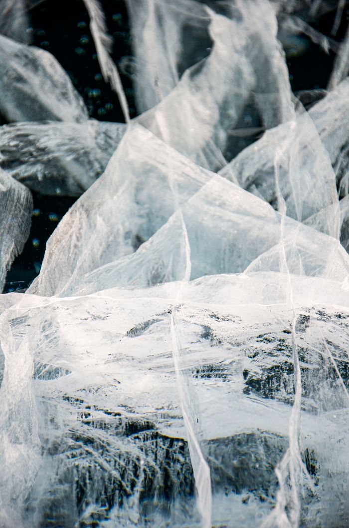 services-07 Close-up view of natural ice formations displaying unique crystalline structures on a frozen lake.